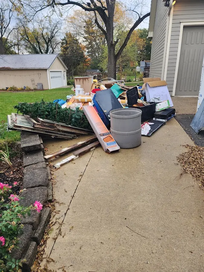Dumpster being loaded with debris for Estate Cleanout Dumpster Rental in Goddard